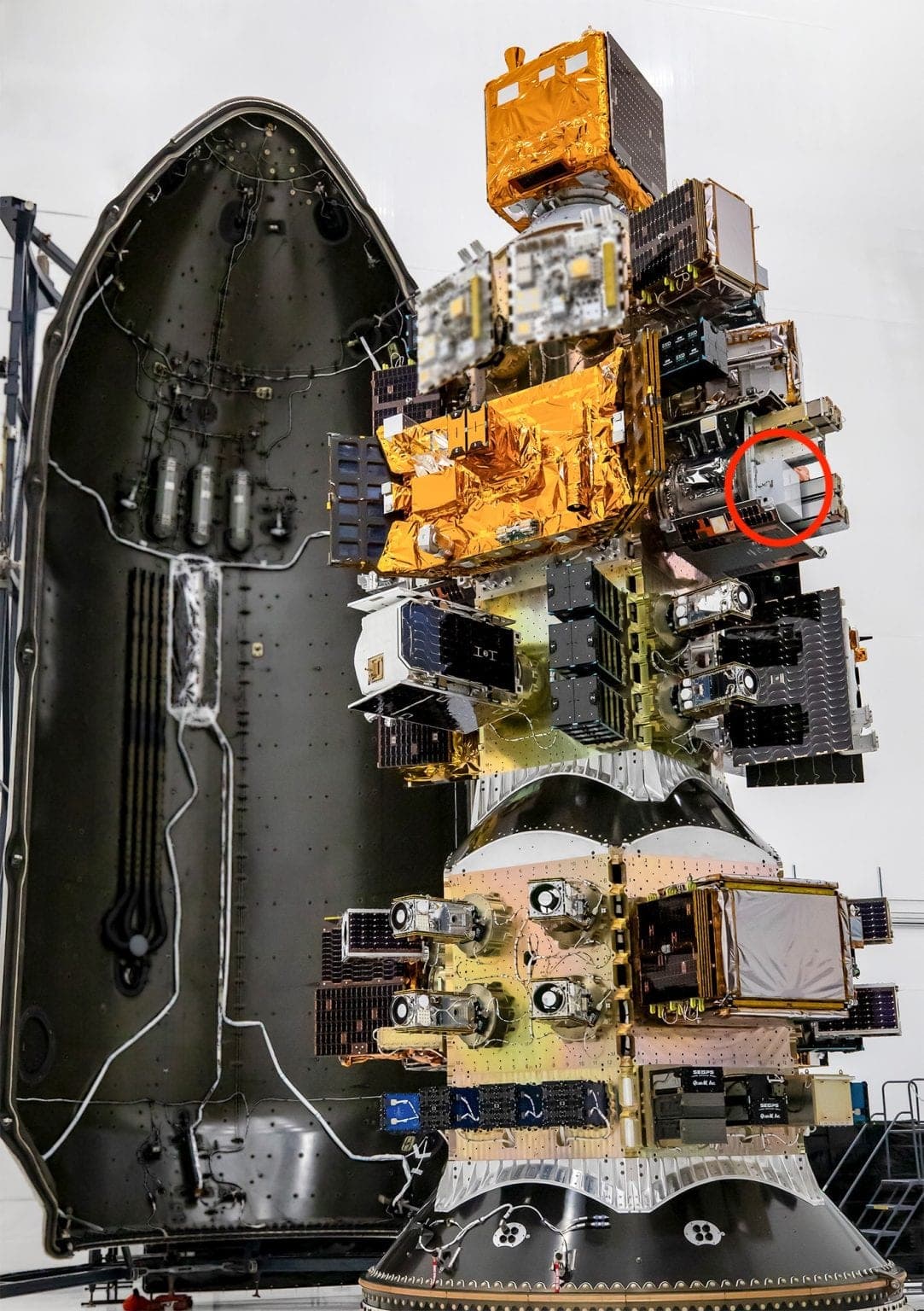 Spaceium's refueling payload, circled in red, mounted among other satellites on a rideshare dispenser inside a launch fairing.