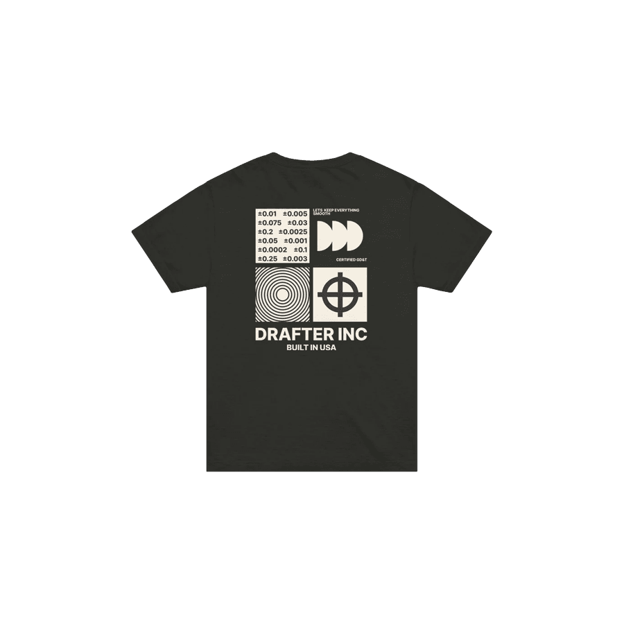 The back of a black tee printed with a grid of tolerance values, concentric rings and a position symbol, over the words Drafter Inc, built in USA.